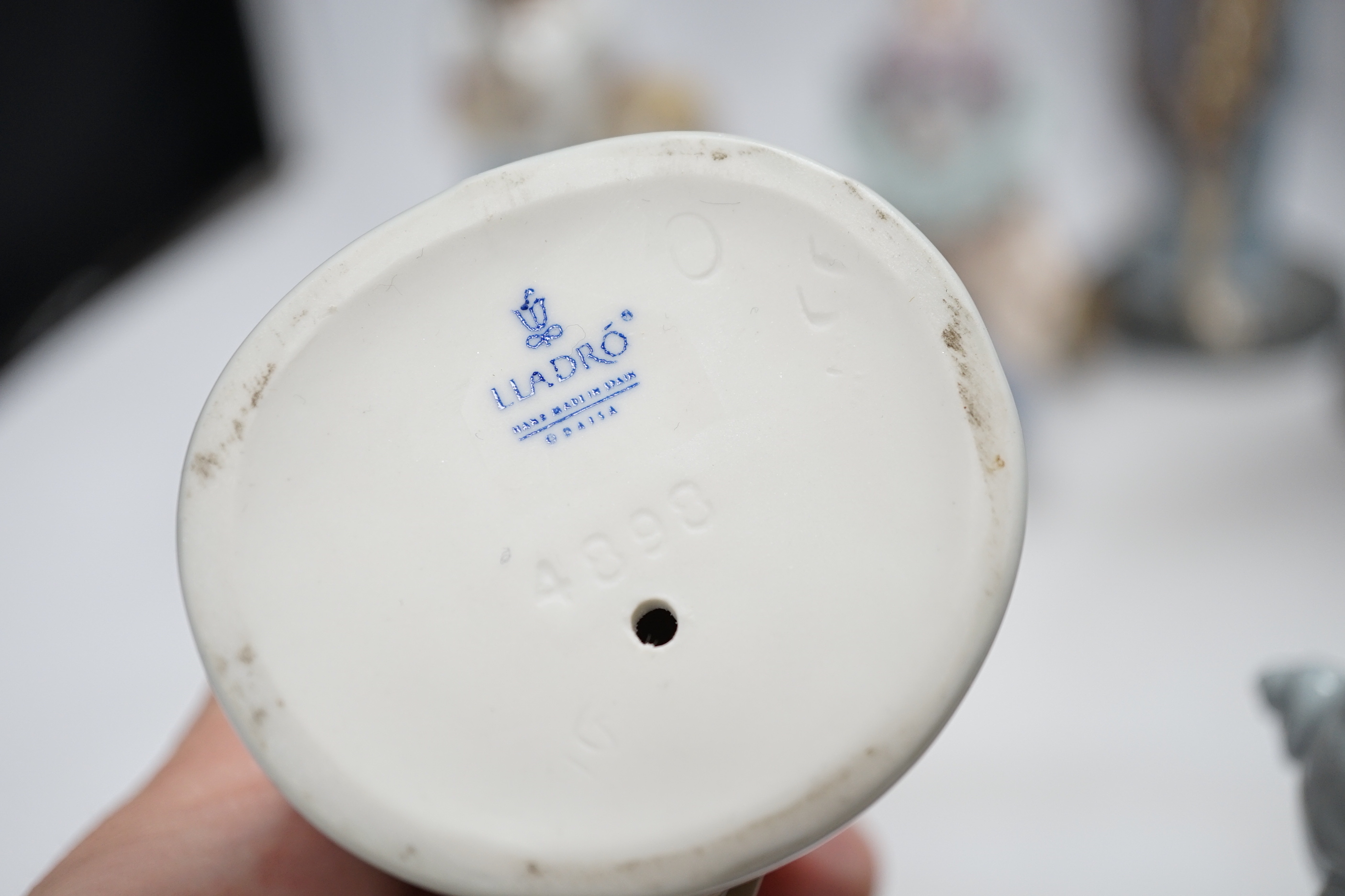 A collection of twelve Lladro figures and a Lladro plaque